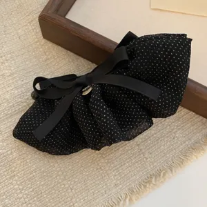 Black polka dot bow hair clip with satin ribbon and metal tag, vintage elegant hair accessory.