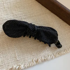 Elegant black polka dot bow hair claw clip for women, vintage style delicate hair accessory.