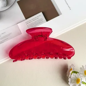 Primo piano di una pinza per capelli jelly trasparente rosa vivo, design lucido ed elegante.