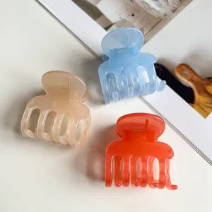 Close-up detail of translucent jelly hair claws in multiple colors featuring metal springs.