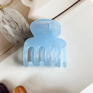 Blue jelly hair claw clip detail shot, elegant resin shark clip for women and girls daily styling.