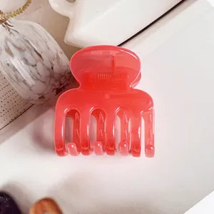 Close-up detail of the translucent pink jelly hair claw clip, perfect for stylish updos.
