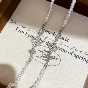 Exquisite pearl and sparkling zircon four-leaf clover detail, showing elegant French retro style.