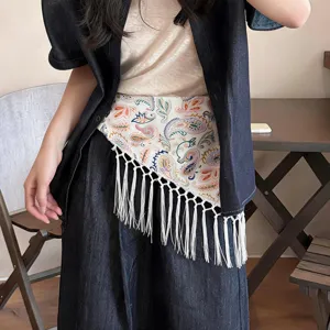 Bohemian paisley triangular scarf with fringe, stylish women layering waist belt for vacation.