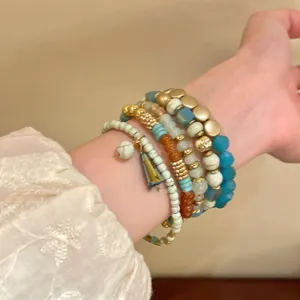 Bohemian multi-layer beaded bracelet set, acrylic and metal charms for women's daily wear.