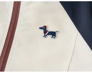 Children jacket detail featuring cute dachshund embroidery, contrast color design and zipper.