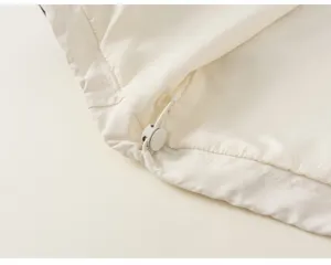 Children's clothing detail shot showing adjustable drawstring hem and soft fabric texture.