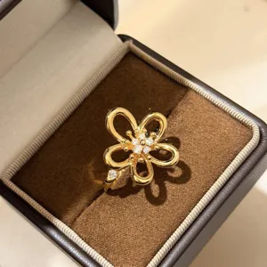 Close-up detail of the elegant openwork floral zircon open ring in a luxury velvet box.