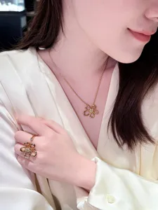 Gold flower zircon openwork necklace and ring set, elegant detail jewelry fashion accessory.