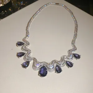 Detail view of the luxury purple teardrop zircon necklace featuring sparkling silver waves.