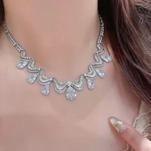 Close-up detail of the stunning wavy rhinestone teardrop pendant necklace, sparkling brilliantly.