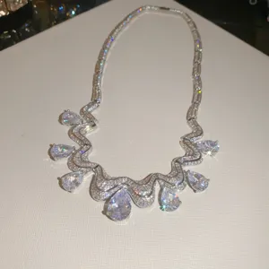 Close-up detail shot of luxury silver-toned cubic zirconia teardrop pendant necklace sparkle.