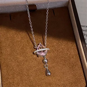 Detailed close-up view of the elegant pink teardrop planet pendant necklace in a luxury box.