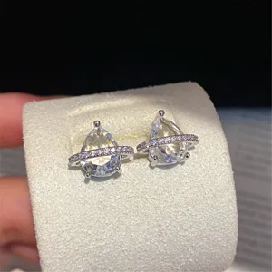 Exquisite pear-shaped cubic zirconia Saturn orb earrings sparkle brilliantly in close-up.