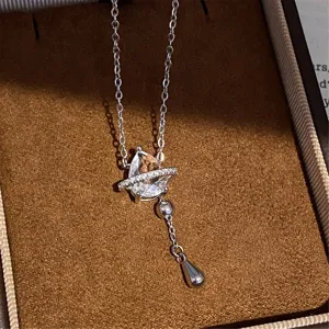 Detailed close-up view of the silver zircon teardrop necklace showcased in velvet box.