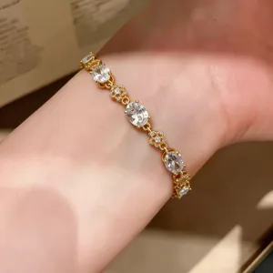 Delicate 18k gold plated cubic zirconia oval and floral bracelet detail showcasing sparkling gems.