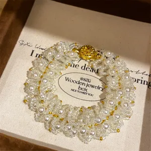 Pulsera tejida a mano con cuentas de perlas y abalorios con cierre dorado vista de detalle
