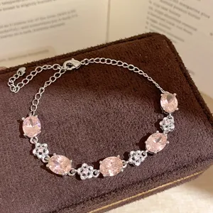 Exquisite pink cubic zirconia floral bracelet, elegant silver chain detail for women.