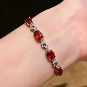 Exquisite red oval zircon crystal flower bracelet detail, elegant fashion wrist jewelry.