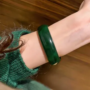 Dark green resin round bangle detail view, showcasing the smooth texture and elegant design.