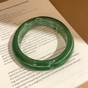 Dark green resin round bangle with marble texture, minimalist aesthetic hand jewelry accessory for women.