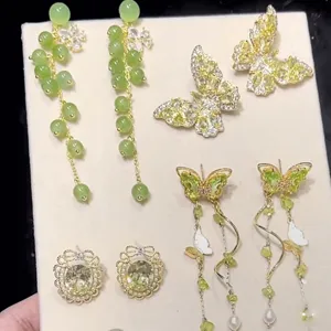 Detailed view of exquisite green zircon butterfly and tassel earrings showcase close-up.