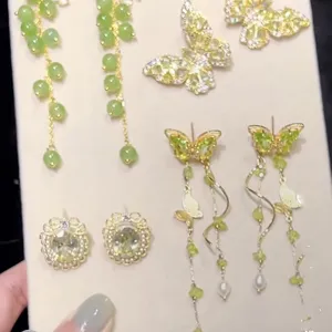 Green zircon butterfly tassel earrings and elegant floral stud set for chic style.