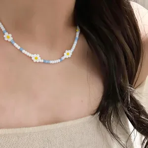 Detailed shot of a charming beaded flower necklace with cute daisy motifs and crystal beads.