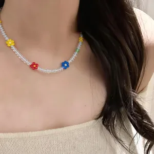 Closeup detail shot of a cute colorful crystal beaded flower clavicle necklace worn gracefully.