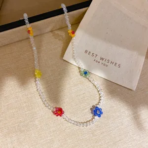 Close up detail of colorful crystal flower beaded necklace with clear beads design style