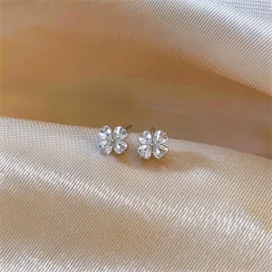 Four-petal flower cubic zirconia stud earrings, elegant detailed view product design.