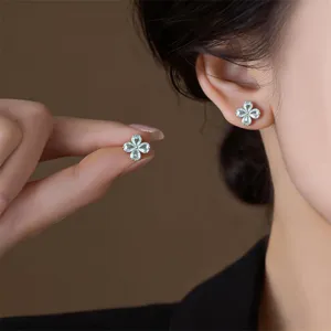 Delicate four-leaf clover zircon stud earrings, elegant heart-shaped floral design for women.