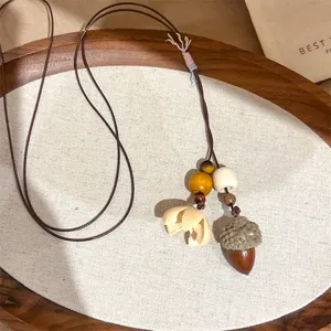 Boho style vintage acorn necklace with wooden beads and natural plant pendant for women.