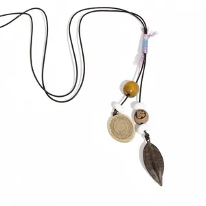 Ethnic vintage boho leaf pendant necklace for women, stylish fashion statement leather cord necklace.