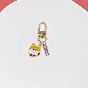 Close-up shot of the cute shiba inu dog alloy keychain pendant with handmade tag detail.