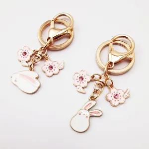 Cute pink alloy keychain featuring adorable rabbit and cherry blossom crystal charms.