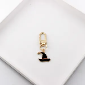 Detailed close-up view of the Halloween witch hat metal keychain pendant, fine craftsmanship.