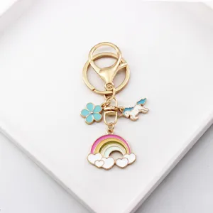 Detailed shot of cute unicorn rainbow metal keychain with colorful enamel charms for bags.