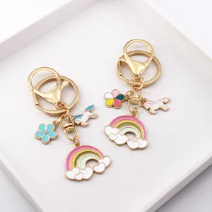 Cute unicorn keychain with colorful rainbow and cloud enamel metal charms for bags and keys.