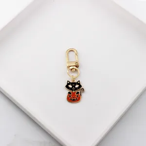Halloween black cat pumpkin metal keychain detail view, cute alloy bag charm pendant accessory.