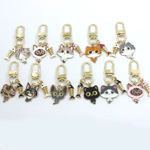 Cute alloy cat keychain with fish bone pendant, creative cartoon bag and car key charm.
