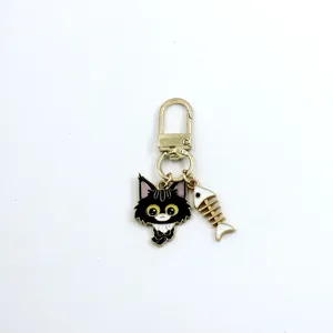 Cute alloy cat keychain with fishbone pendant, mini gold-tone metal bag charm for keys and headphones.