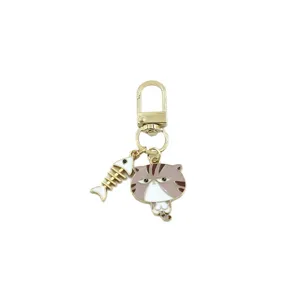 Cute alloy cat keychain with fishbone pendant, mini metal bag charm and car key ring accessory.