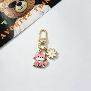 Cute metal cat keychain with daisy pendant, stylish gold bag charm and accessories for women.