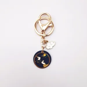 Close-up of alloy dripping oil keychain with cute moon rabbit and cloud pendant detail.