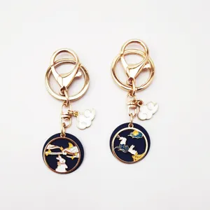 Close-up of alloy enamel keychain featuring rabbit moon and cloud charm design, gold finish.