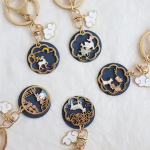 Detailed view of cute alloy enamel keychains featuring various animal and cloud charms.