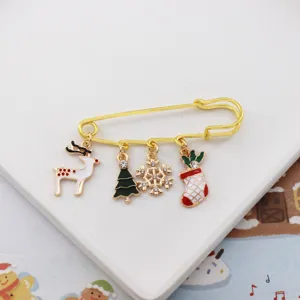 Christmas alloy safety pin brooch with cute reindeer tree snowflake and stocking charms.