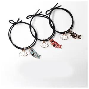 Close-up detail of Japanese style koinobori alloy hair ties with cute cloud charms.