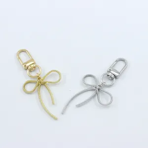 Korean style metal bow keychain pendant, cute bag charm and phone case decorative accessory.